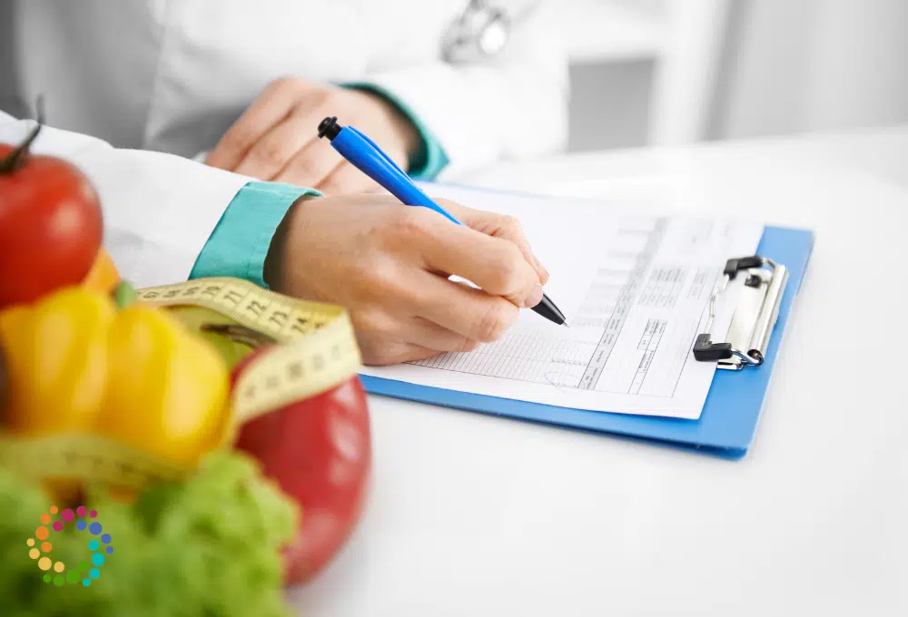 Doctor writing on clipboard with produce and a tape measure on the table